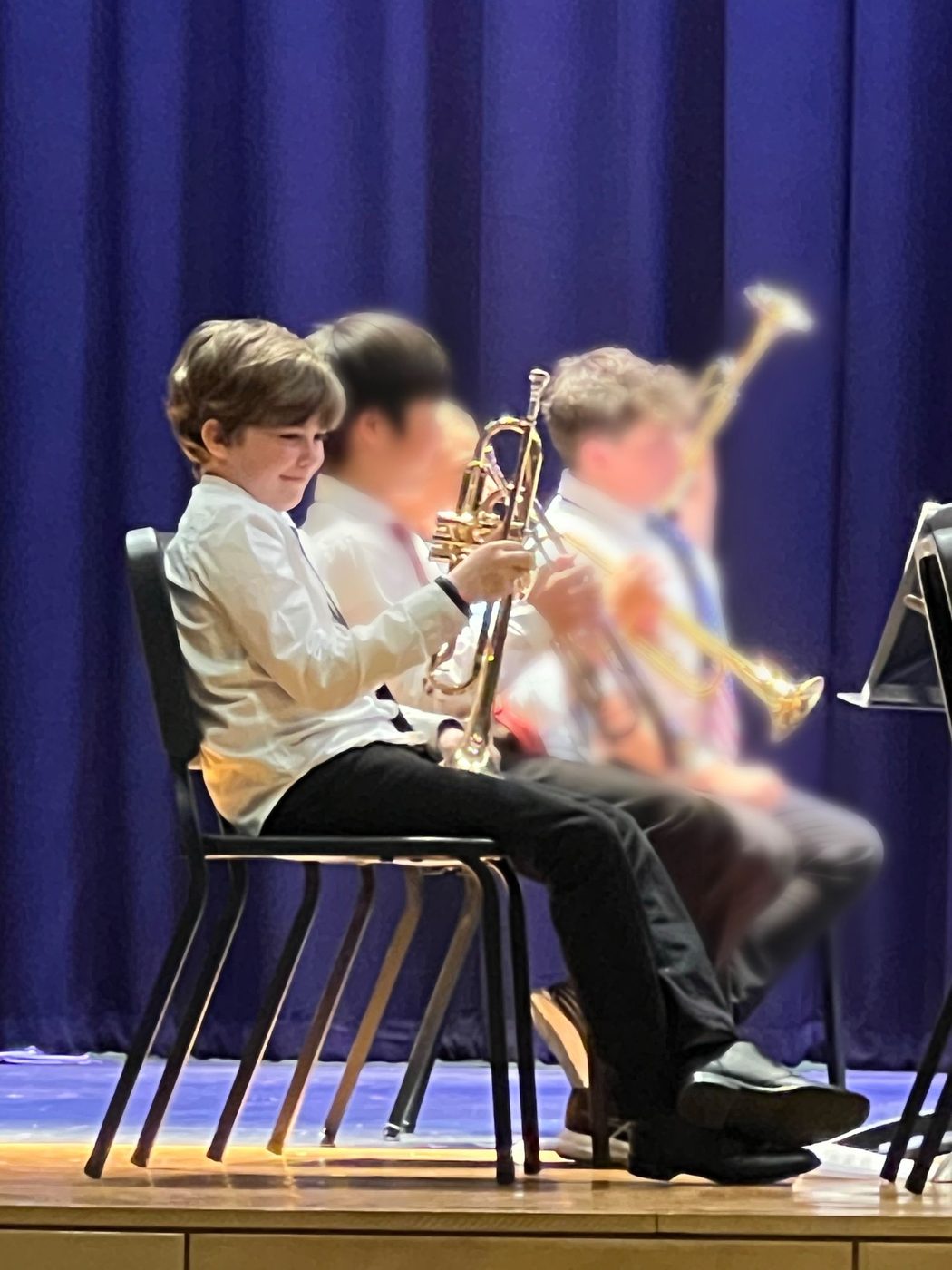 Students on stage with their trumpets